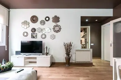 a living room with a flat screen tv on a wall at Stay U-nique Apartment Parallel in Barcelona