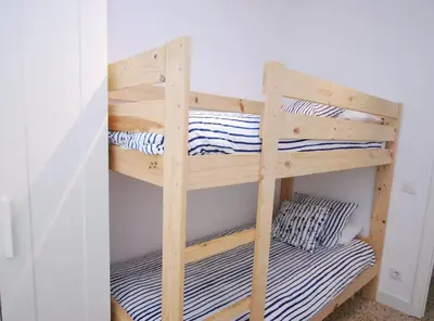 a wooden bunk bed in a room at Can Josep in Vilassar de Mar