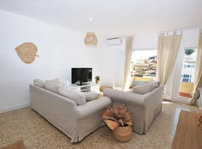 a living room with two couches and a tv at Can Josep in Vilassar de Mar