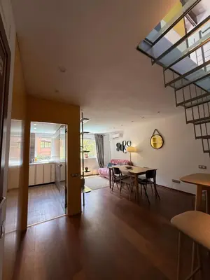 a living room and dining room with a skylight at Maravilloso piso en el corazón de Barcelona in Barcelona