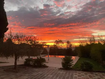a sunset with a cloudy sky in a park at Habitación suite en Masía Can Robira in Els Hostalets