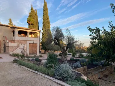 a house with trees and a garden in front of it at Habitación suite en Masía Can Robira in Els Hostalets
