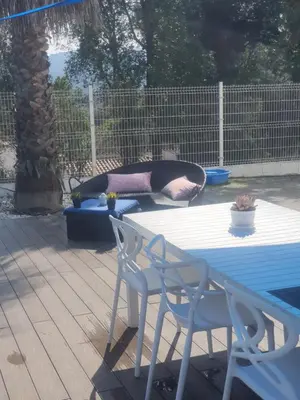 a person laying in a swimming pool with a blue umbrella at Spa Ibiza Dosrius - Bungalow con Jacuzzi y Piscina privada in Canyamás