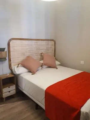 a bed with two pillows on it in a room at APBCN Eixample Center in Barcelona