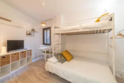 a bedroom with two bunk beds and a desk at Welcomy Sant Andreu in Barcelona