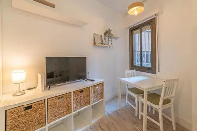 a room with a desk and a tv and a table at Welcomy Sant Andreu in Barcelona