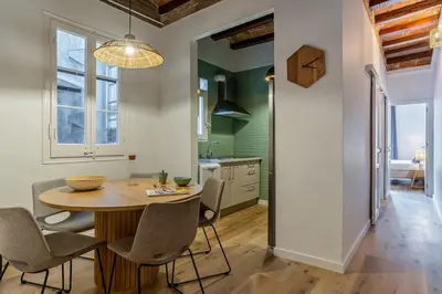 a kitchen and dining room with a table and chairs at Canela Homes BARCELONA CÒRSEGA in Barcelona