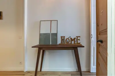 a wooden table with a mirror on top of it at Canela Homes BARCELONA CÒRSEGA in Barcelona
