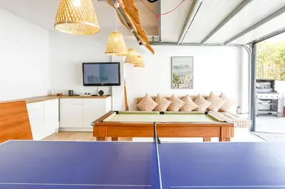 a living room with a ping pong table at Tranquil large 6 bedroom family Villa sleeps 20 near sitges in Sant Pere de Ribes