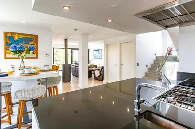 an open kitchen and living room with a counter top at Tranquil large 6 bedroom family Villa sleeps 20 near sitges in Sant Pere de Ribes