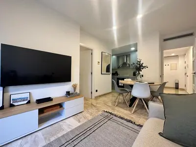 a living room with a large flat screen tv at Cozy Apartment Les Corts in Barcelona