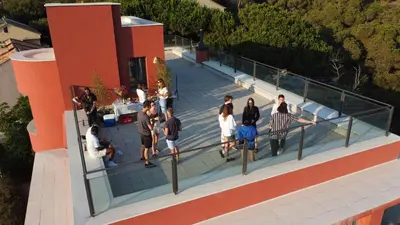 a group of people standing on top of a building at Circles House Coliving & Coworking in Barcelona