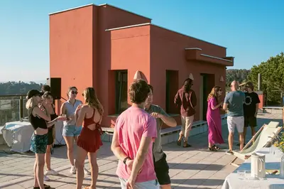 a group of people standing on the roof of a building at Circles House Coliving & Coworking in Barcelona