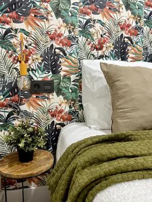 a bedroom with a bed and a floral wallpaper at Crysoyle Apartment Barcelona Next to Camp Nou in Hospitalet de Llobregat