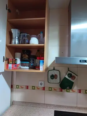 a kitchen cabinet filled with lots of food at Casa Ferrer Barcelona in Hospitalet de Llobregat