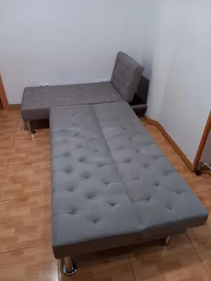 a bed sitting in a room next to a wall at Casa Ferrer Barcelona in Hospitalet de Llobregat