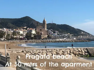 a view of a beach with the words ricardo beach at miles at Blaumar in Sitges