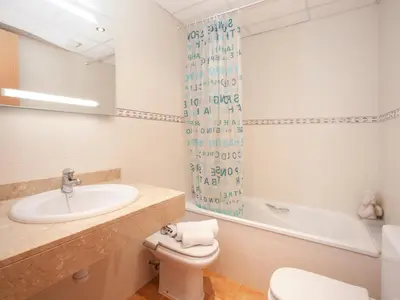 a bathroom with a sink and a toilet and a shower at Blaumar in Sitges