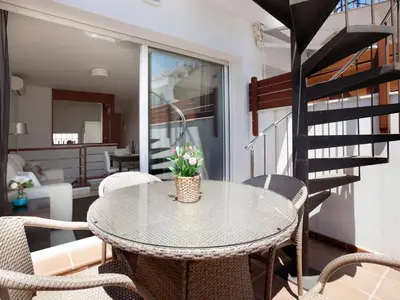 a dining room with a table and chairs at Blaumar in Sitges