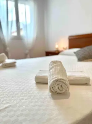 two towels sitting on top of a bed at Apartamento St Agustí - Centro in Mataró