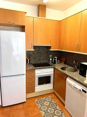 a kitchen with a white refrigerator and a sink at Apartamento St Agustí - Centro in Mataró