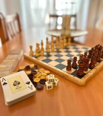a chess board with tokens and dice on a table at Apartamento St Agustí - Centro in Mataró