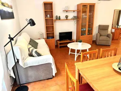 a living room with a couch and a table at Apartamento St Agustí - Centro in Mataró