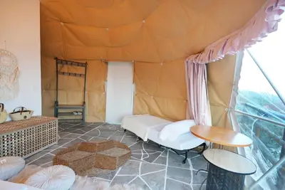 a living room with a tent at AAA View Private Terrace Outdoor Heated Hot Tub Family Fun in Badalona