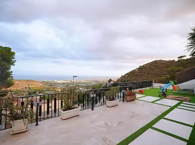 a balcony of a house with a view of the ocean at A+View Private Terrace Private Pool Family Fun in Badalona