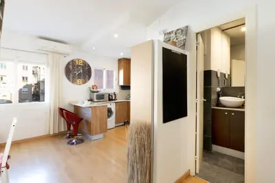 a kitchen with a large refrigerator in a room at Cute Apartment in Sants Station with HBO & Alexa & AC in Barcelona