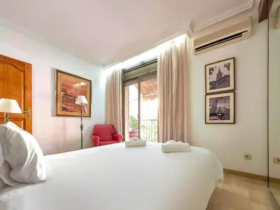 a bedroom with a large white bed and a window at Stay U-nique House Torre Damians in Barcelona