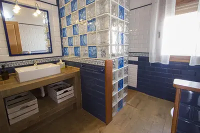 a bathroom with a sink and blue and white tiles at Catalunya Casas Indoor and Outdoor Pools, Sauna, Gym, Games Area in Sant Pau dʼOrdal