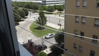 a view from a window of a street with a car at Apartamentos Atlas Terrassa I in Terrassa