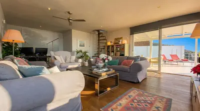 a living room with couches and a table at Villa Sitges Altavista Amazing View South oriented Calm Area AC Beach 2 minutes Drive and 18 minutes Walk in Sitges