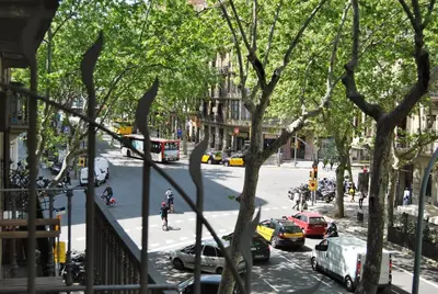 a view of a city street with cars and buses at Rafael Music Palace apartment in Barcelona