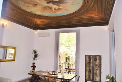 a dining room with a ceiling with a painting at Rafael Music Palace apartment in Barcelona