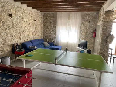 a living room with a ping pong table in it at Cal Tomaset in Les Cabanyes