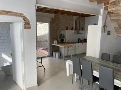 a kitchen with a table and chairs in a kitchen at Cal Tomaset in Les Cabanyes