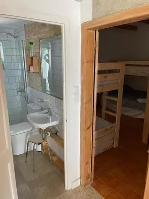 a bathroom with a sink and a bunk bed at Cal Tomaset in Les Cabanyes