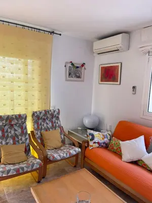 a living room with two chairs and a couch at Cunit Beach in Cunit