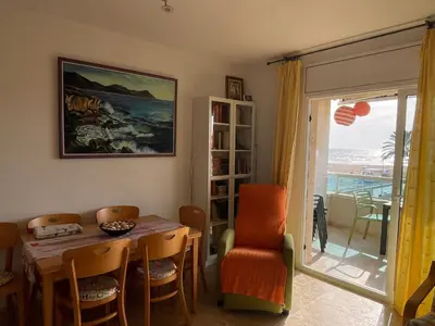 a dining room with a table and chairs and a window at Cunit Beach in Cunit