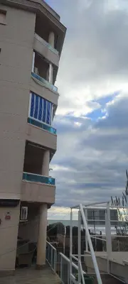 a building with blue and white balconies on it at Cunit Beach in Cunit