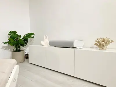 a white cabinet with a laptop on top of it at White Apartment Barcelona in Barcelona