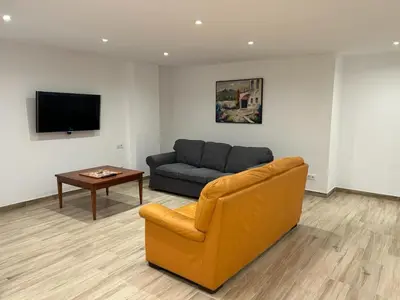 a living room with a couch and a table at APARTAMENTO EN LA PLAYA in Pineda de Mar