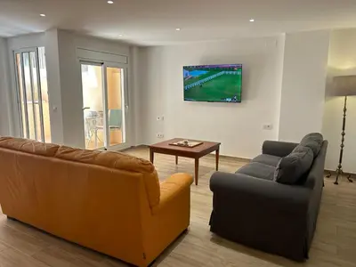a living room with a couch and a table at APARTAMENTO EN LA PLAYA in Pineda de Mar