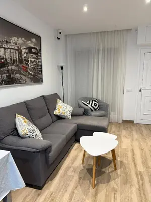 a living room with a couch and a table at APARTAMENTO EN LA PLAYA in Pineda de Mar