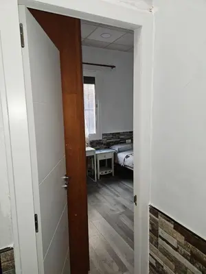an open door to a bedroom with a bed at Habitación doble con baño privado in Hospitalet de Llobregat