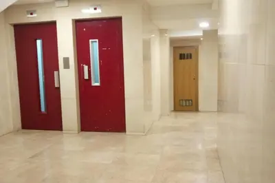 a hallway with two red doors in a building at Glorias:Sagrada Familia 15 minutos - Playa 20 minutos in Barcelona