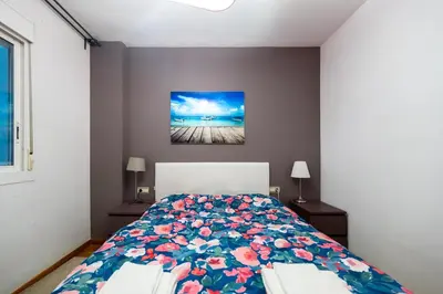 a bedroom with a bed with a floral bedspread at Comfy Downtown + Private terrace in Barcelona