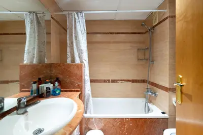 a bathroom with a sink and a shower and a tub at Comfy Downtown + Private terrace in Barcelona